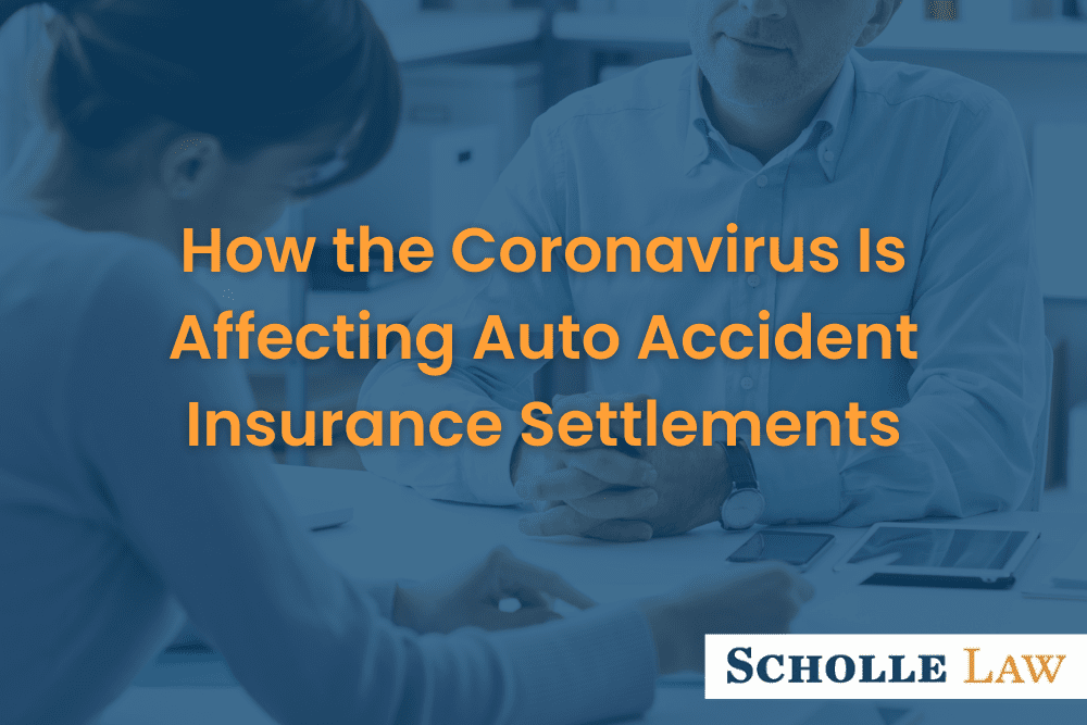 woman reviewing paperwork with businessman, How Coronavirus is Affecting Auto Accident Insurance Settlements