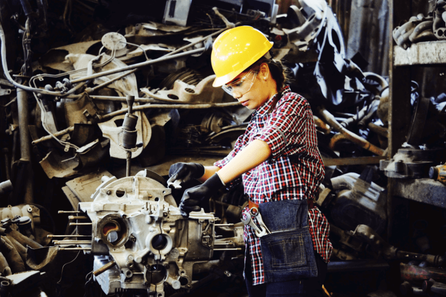 Woman Wears Yellow Hard Hat Working At Vehicle Factory