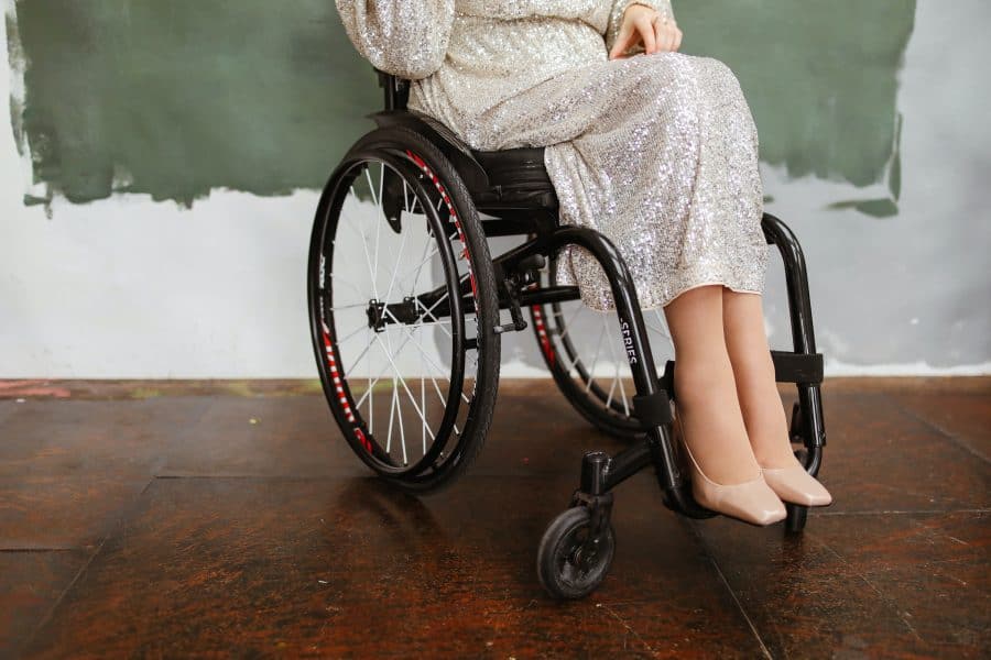 Woman in White Robe Sitting on Black Wheelchair