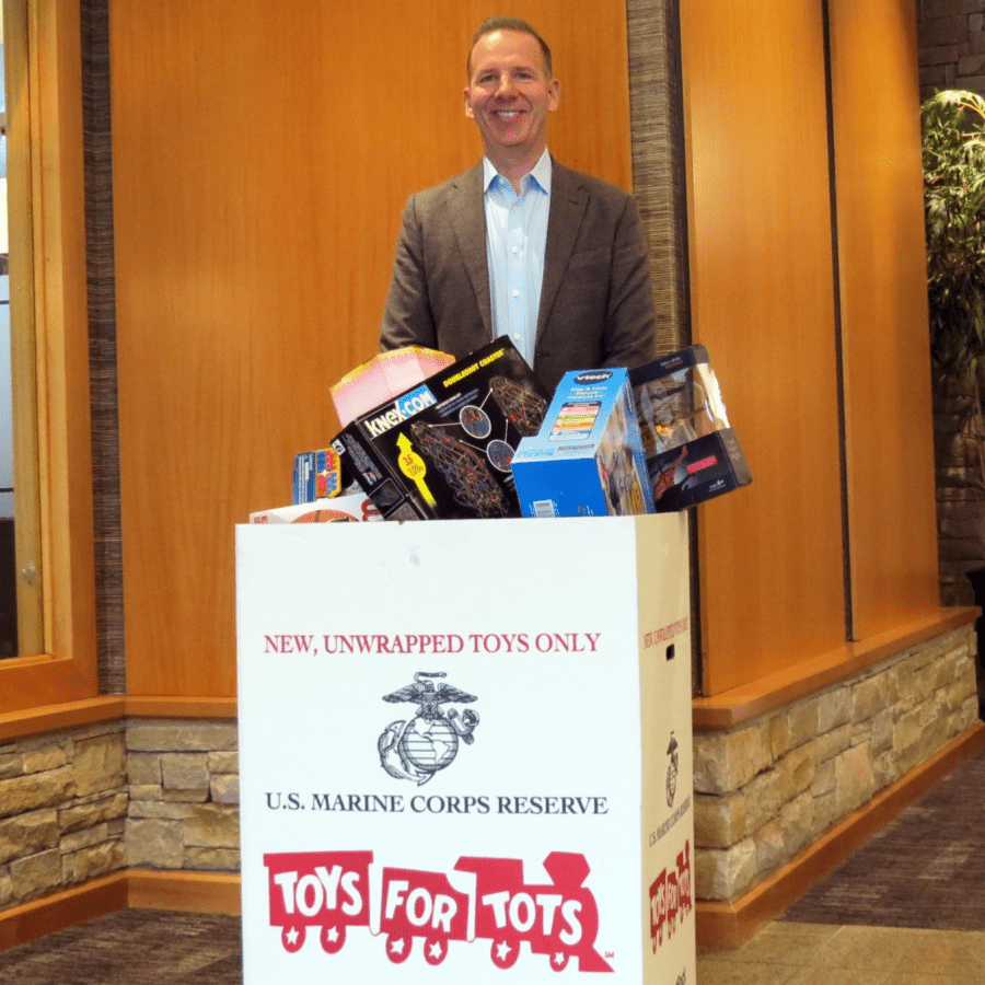 Attorney Charles Scholle with gifts gathered for Toys for Tots 2021.