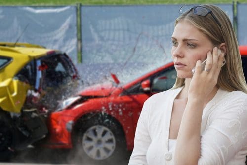 woman talking on phone after car accident