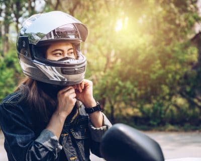 woman wearing a motorcycle helmet before riding