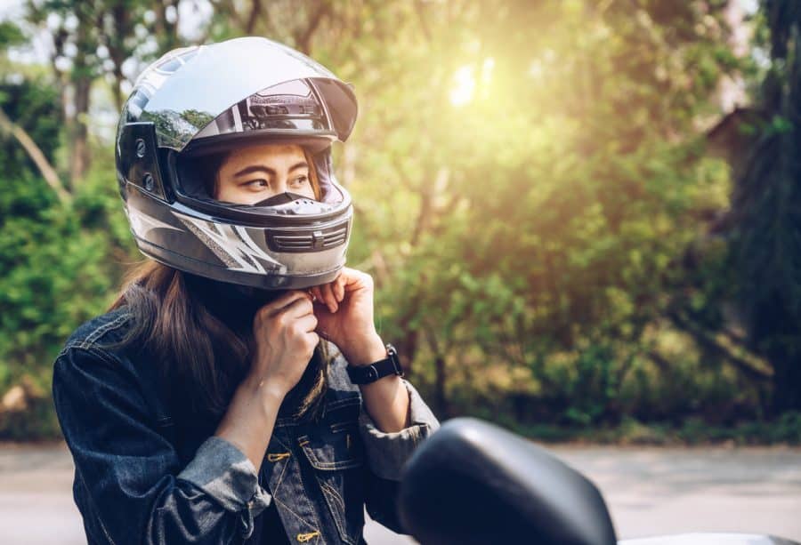 woman wearing a motorcycle helmet before riding