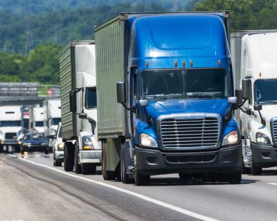 A long steady line of truck traffic on a busy interstate