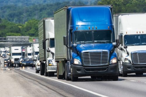 A long steady line of truck traffic on a busy interstate