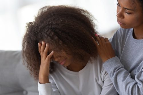 African American mom hug comforting sad teenage daughter