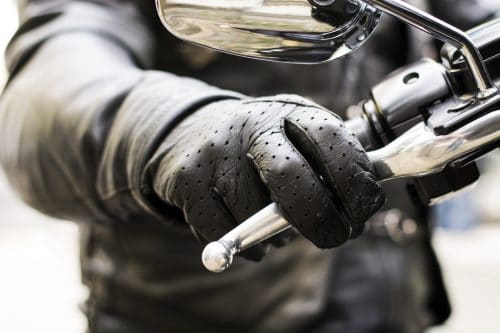 Biker's hand on brake lever handlebar