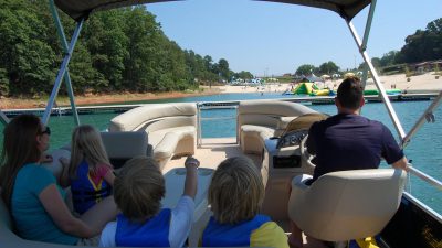 Boating with children wearing life vests on the lake