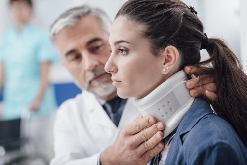 Doctor visiting a patient with cervical collar