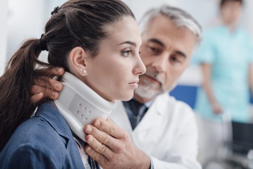 Doctor visiting a patient with cervical collar