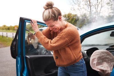 Female Motorist In Crash For Crash Insurance Fraud Getting Out Of Car