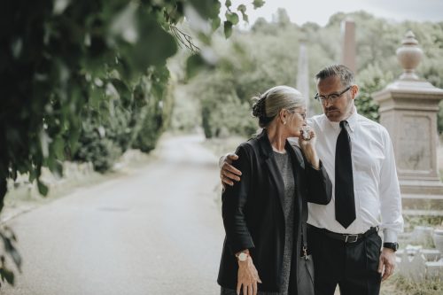 Husband trying to comfort his wife due to her loss