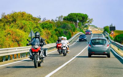 Motorcycles and cars on road