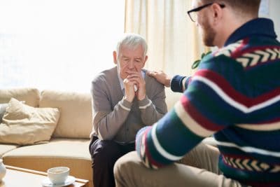 Psychologist Comforting Senior Man