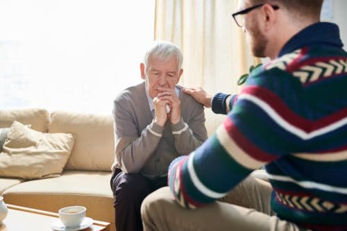 Psychologist Comforting Senior Man