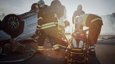 Rescue Team of Firefighters Pull Female Victim out of Rollover Vehicle