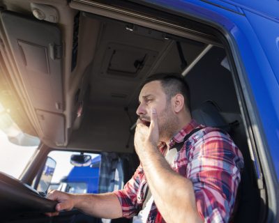 Truck driver yawning while driving