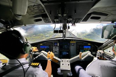 View of cockpit with pilot and co-pilot preparing for landing