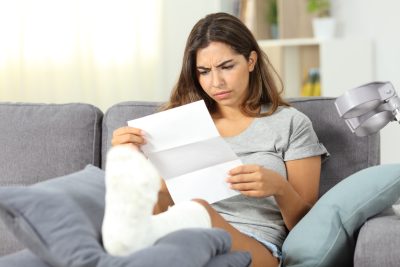 Worried disabled woman reading a letter
