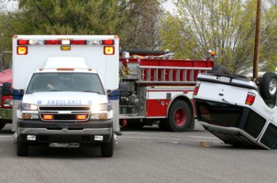 Overturned SUV with ambulance and fire truck