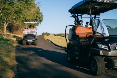 Golf carts on concrete pathway