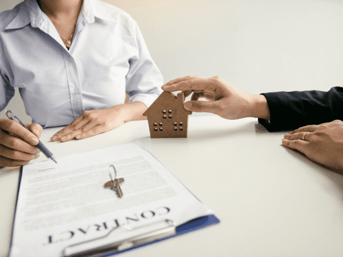 a woman signing a contract