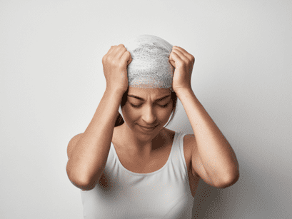 women with her hands on her head