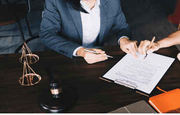 lawyer helping client fill out paperwork