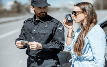 woman taking a breathalyzer test