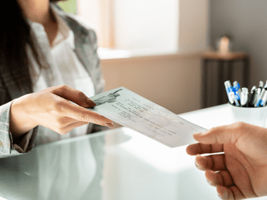 woman receiving a check from the hospital