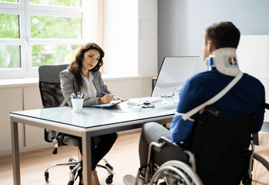 man in a wheelchair talking to lawyer