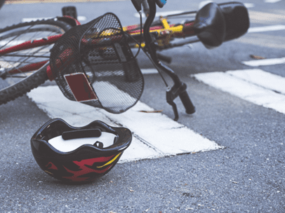 bicycle and helmet laying in the crosswalk