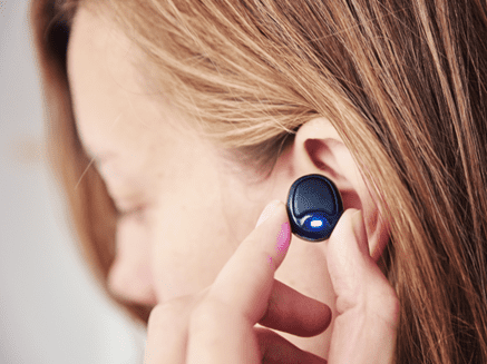 women putting in wireless ear piece