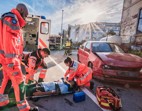 man being carried away on a stretcher