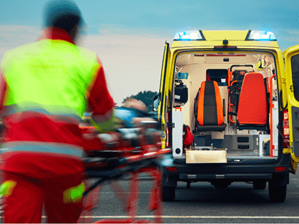 man being rushed into an ambulance