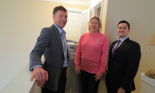 In the Community 21 Scholle Law attorneys with the recipient of the new water heater