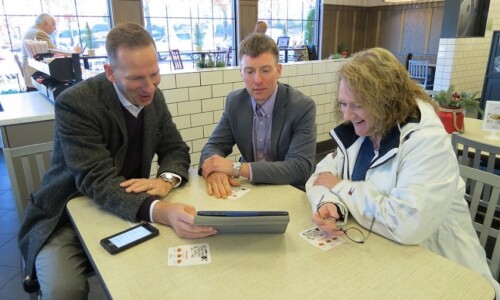 In the Community 12 Scholle Law staff meeting with 104.7 The Fish radio host for Christmas Wish